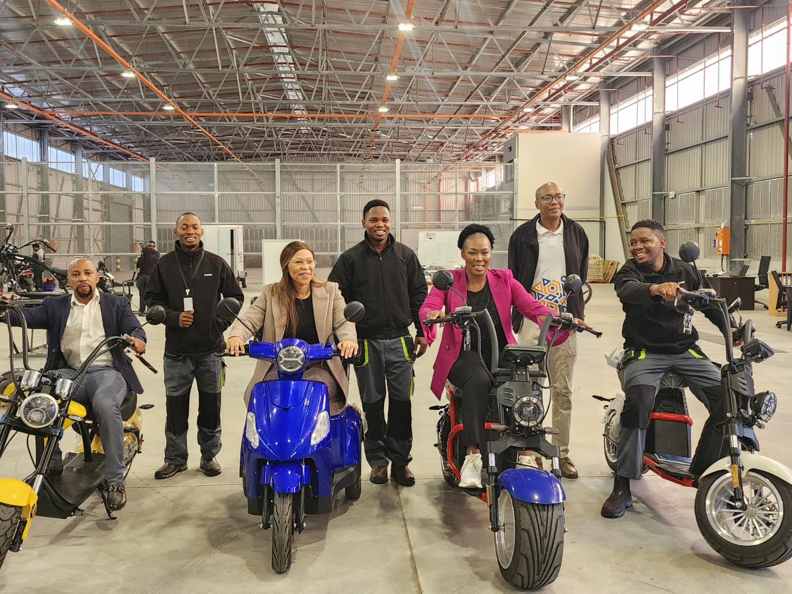 Team and guests with the E-Cruizer range on the factory floor