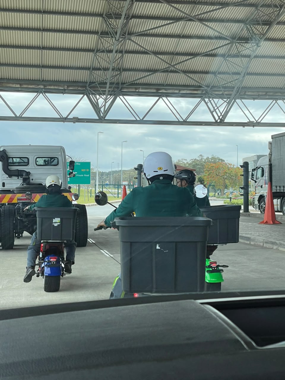 Style E-Bikes riders with cargo crates sharing the road with cars and trucks