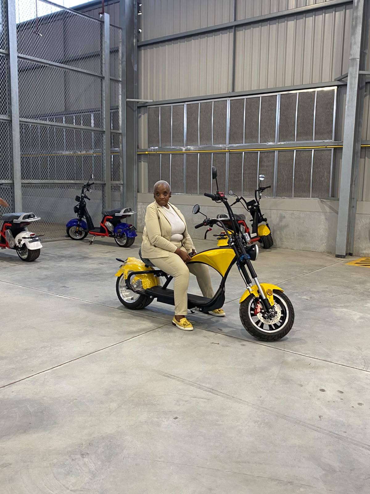 Customer seated on a yellow electric chopper inside the facility